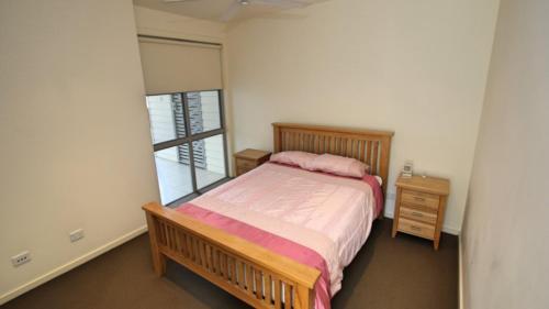 a small bedroom with a bed and a window at 8 - 22 Bennett St, Hawks Nest in Hawks Nest