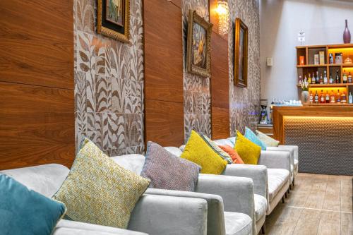 a row of couches with colorful pillows on them at Charm Hotel Budapest - formerly Boutique Hotel Budapest in Budapest