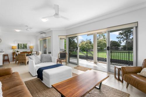 a living room with a couch and a table at Riviera Noosa Resort in Noosaville