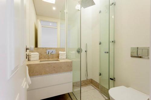 a bathroom with a sink and a shower at FLH Mouraria Art Apartment with Pool in Lisbon