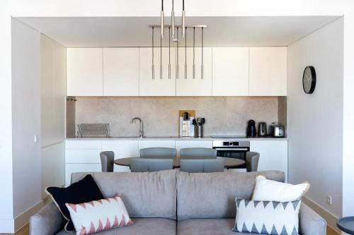 a living room with a couch and a kitchen at FLH Mouraria Art Apartment with Pool in Lisbon