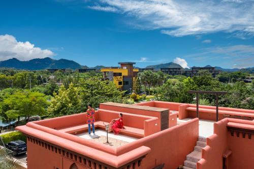 two people standing on top of a roof at The Air Khaoyai Hotel SHA Extra Plus in Mu Si