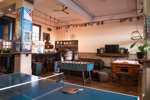 a room with a ping pong table and a bar at Sundancer Backpackers Hostel in Fremantle