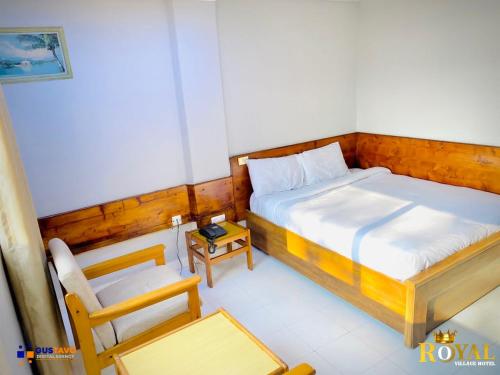 1 dormitorio pequeño con 1 cama y 1 silla en Royal Village Hotel, en Dar es Salaam