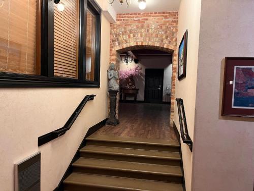 a hallway with stairs and a brick wall at Nuk's Executive Suites in De Pere
