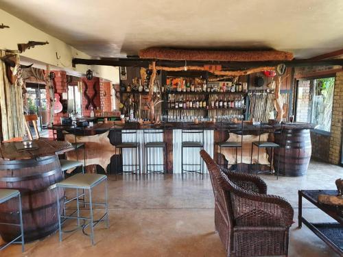a bar with a lot of wine barrels in a room at Nyani Lodge Dinokeng in Pretoria