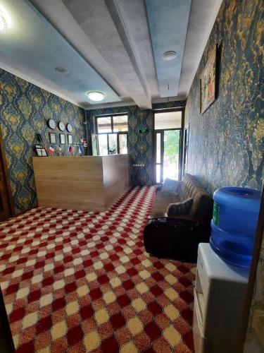 a living room with a checkered carpet at Зона отдых APACHI в горах ЧИМГАН in Chimgan