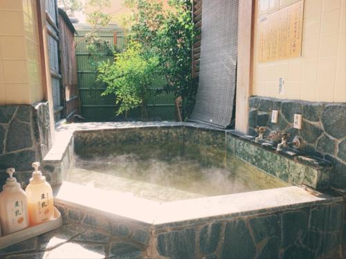 a bath tub with steam coming out of it at KOUBOUNOYU IKONASOU in Shizuoka