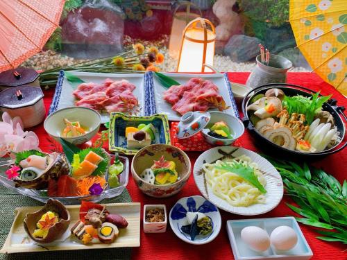 a table topped with plates of food and bowls of food at KOUBOUNOYU IKONASOU in Shizuoka