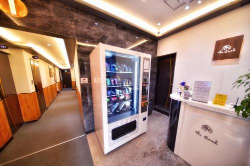 a large refrigerator in a hallway with a counter at The Road Hotel in Seoul