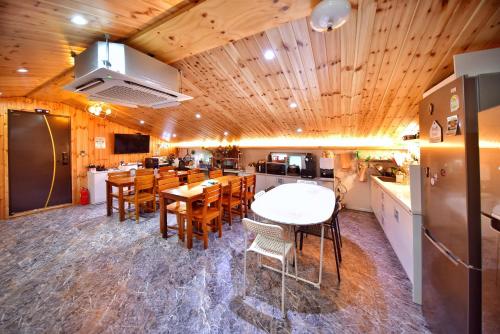 a kitchen and dining room with tables and chairs at The Road Hotel in Seoul