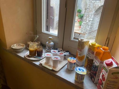 a counter top with breakfast food and a window at Il Borgo Antico in Rocca Massima