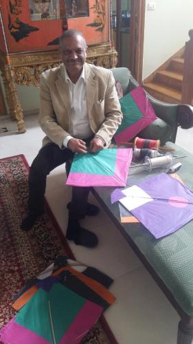 a man sitting on a table with kites on it at Aura Homestay Royal Villa in Jaipur