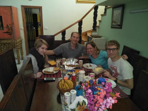 a group of people sitting at a table eating at Aura Homestay Royal Villa in Jaipur