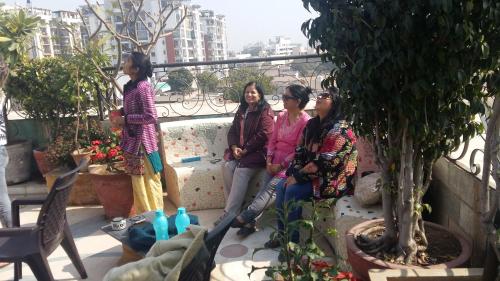 a group of three women standing on a balcony at Aura Homestay Royal Villa in Jaipur