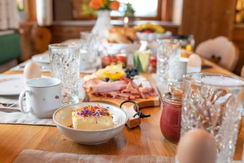 a wooden table with a plate of food on it at Prenner Alm in Haus im Ennstal