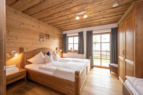 a bedroom with a large bed in a wooden room at Prenner Alm in Haus im Ennstal