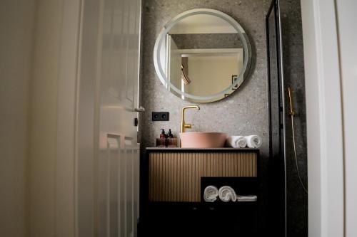 a bathroom with a sink and a mirror at Bob W Peterhof in Freising