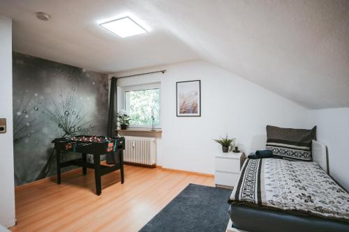a bedroom with a bed and a table at Ferienwohnung Seeblick Wadee in Radolfzell am Bodensee