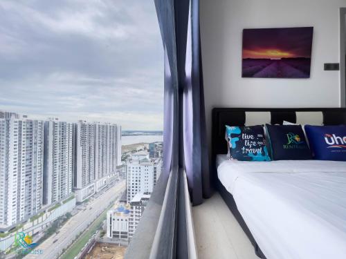 a room with a bed and a view of a city at VSummer Stylish Loft Suites @ UHA in Johor Bahru