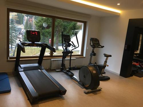 a gym with three exercise bikes and a window at Hotel Rajska dolina Jahorina in Jahorina