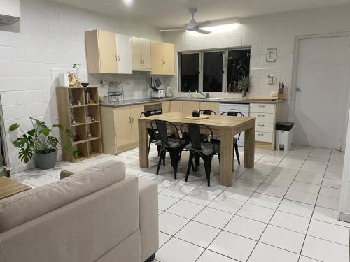 a kitchen with a table and chairs in a room at Withanee in Picnic Bay