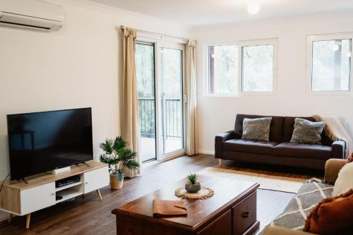 a living room with a flat screen tv and a couch at Premalaya in Yallingup