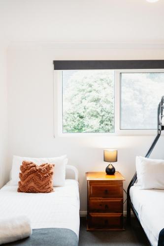 a bedroom with two beds and a window at Premalaya in Yallingup