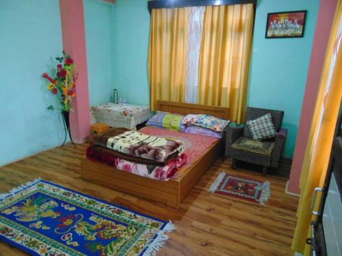a room with a bed and a chair in it at BOJO house in Gangtok