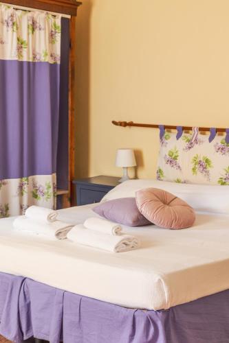 a bed with towels and a pillow on it at Agriturismo Montevecchio Isolani in Monte San Pietro
