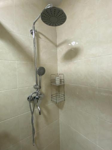 a shower with a shower head in a bathroom at White Oak Residences - Baguio Megatower 3 in Baguio