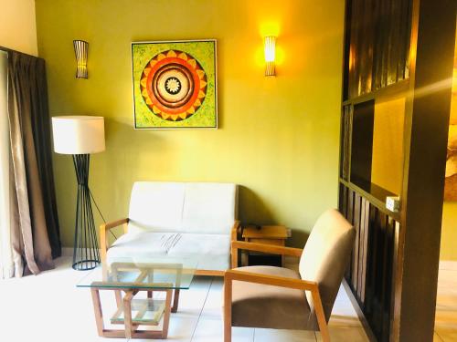 a living room with a couch and a table at 3 room apartment with garden view in Banting