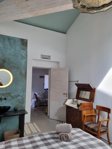 a room with a bed and a table and a chair at Mas de la Petite Jeanne in Grimaud