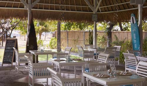 a group of tables and chairs under a pavilion at SOL by Meliá Benoa Bali All inclusive in Nusa Dua