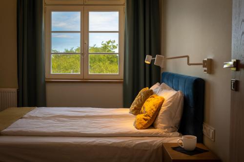 a bed in a room with a window at Villa Bałtycka in Gdańsk