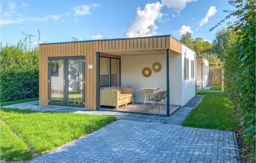 a small shed with a couch in a yard at Lovely Home In Heinkenszand With Sauna in Heinkensand