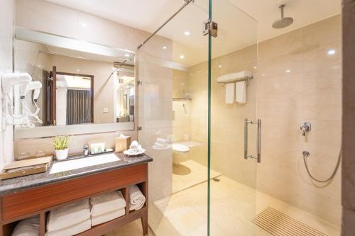 a bathroom with a shower and a sink and a mirror at LP Vilas in Dehradun