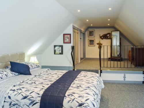 a bedroom with a large bed and a staircase at The Coach House in Cove