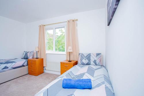 a bedroom with a bed and a window at Intellect Suites in Northampton