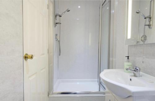 a bathroom with a shower and a sink at Southbank Guesthouse in Elgin