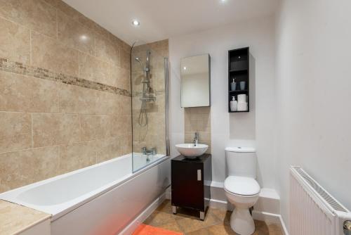 a bathroom with a toilet and a sink and a shower at No 14 in Mansfield