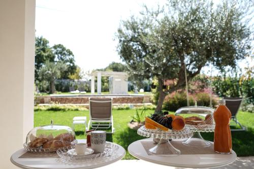 a table with two plates of food on it at ALMASOL - Charme Experience in Castellana Grotte