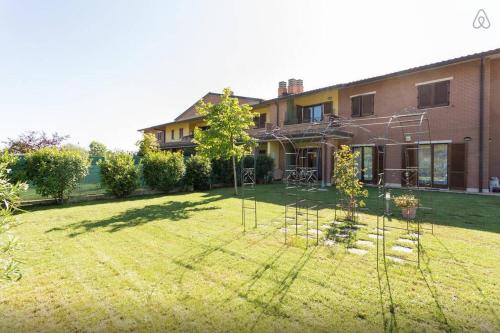 a house with a yard with trees in front of it at La Casa Di Federica in Corciano