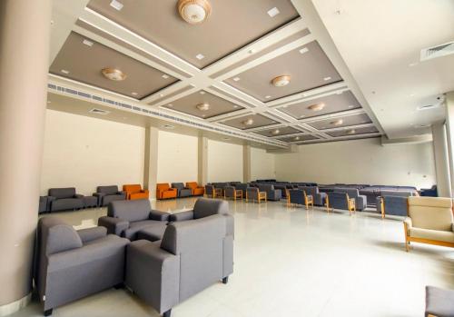 an empty waiting room with chairs and a ceiling at Vinn Amar Vilas by Vesta in Bharatpur