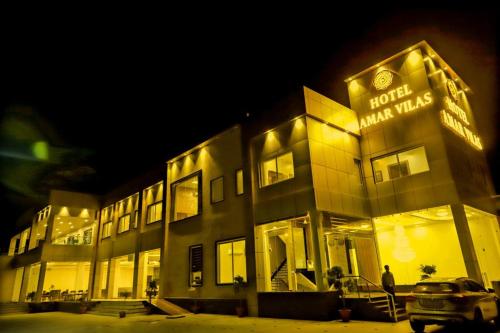 a man standing in front of a building at night at Vinn Amar Vilas by Vesta in Bharatpur
