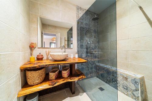 a bathroom with a sink and a mirror at Villa latrille - piscine - sauna - jacuzzi in La Saline les Bains