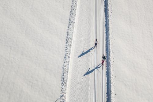 two planes are flying on a road in the snow at Hotel Acherl in Achenkirch