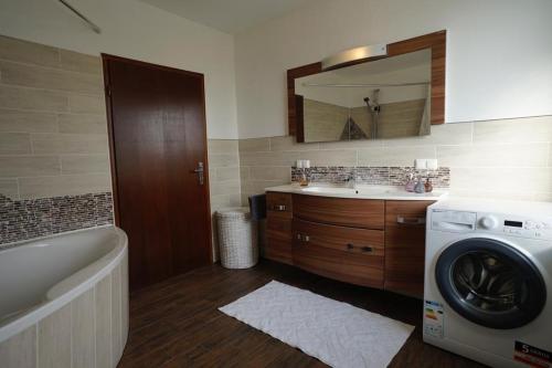 a bathroom with a sink and a washing machine at Gemütliche Unterkunft für bis zu 11 Personen. in Hannover