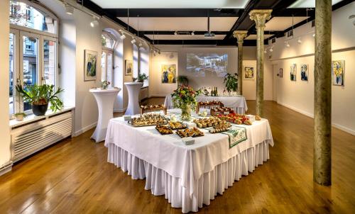 a room with two tables with food on it at Ciarus in Strasbourg