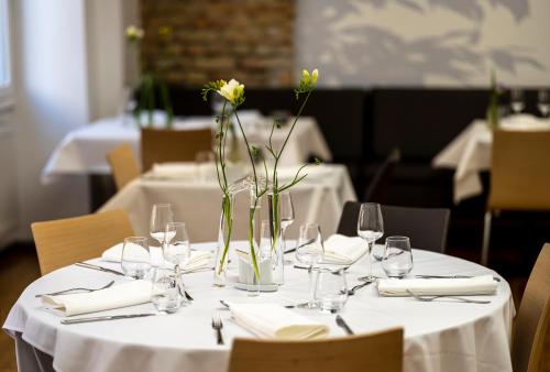 a table with glasses and vases with flowers on it at Ciarus in Strasbourg
